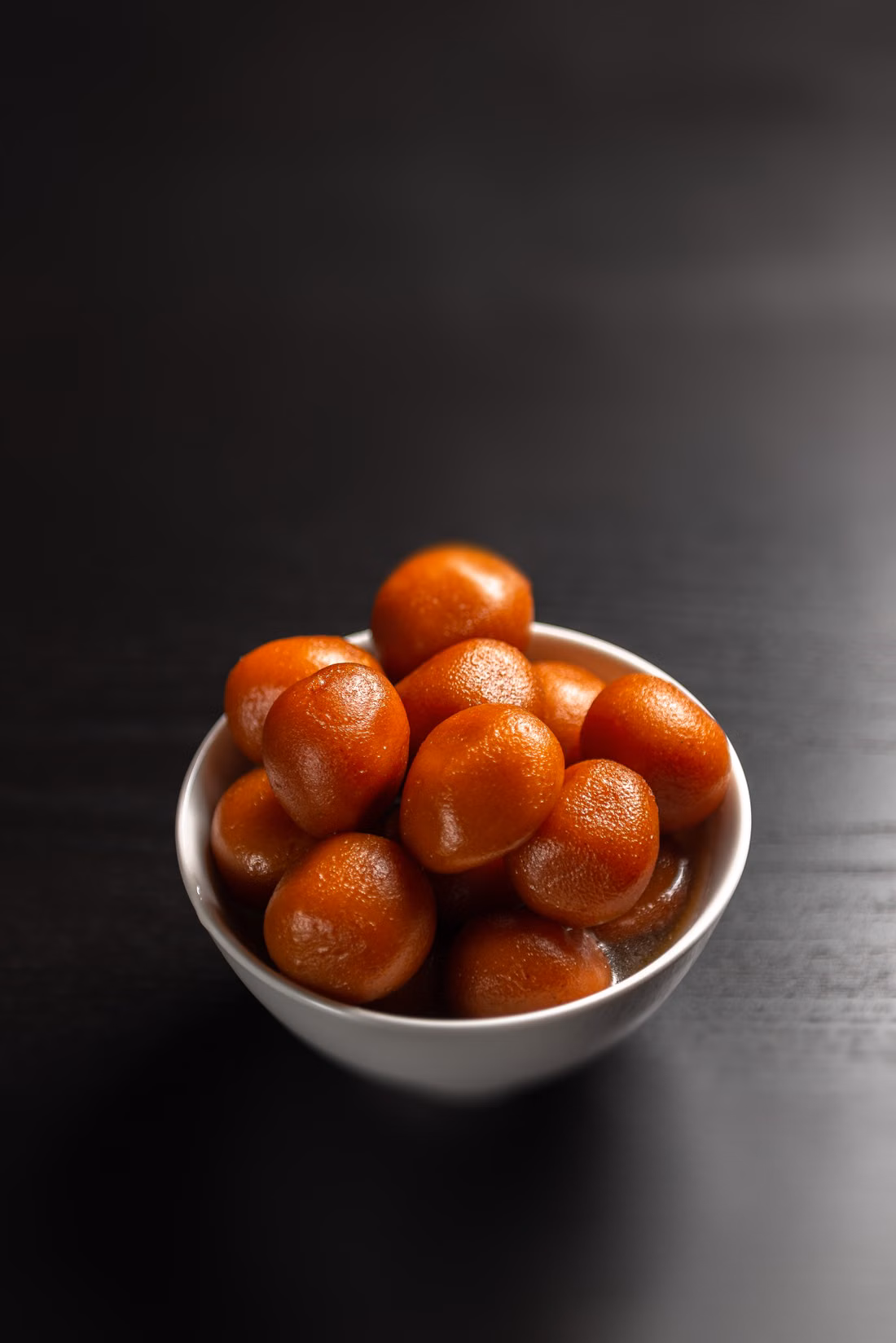 Gulab jamun in a white bowl